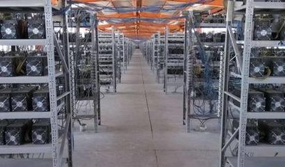 Aerial view of a large-scale mining farm with numerous shipping containers housing mining rigs